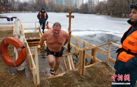 当地时间1月19日，一名俄罗斯居民在结冰的河里浸洗。中新社记者